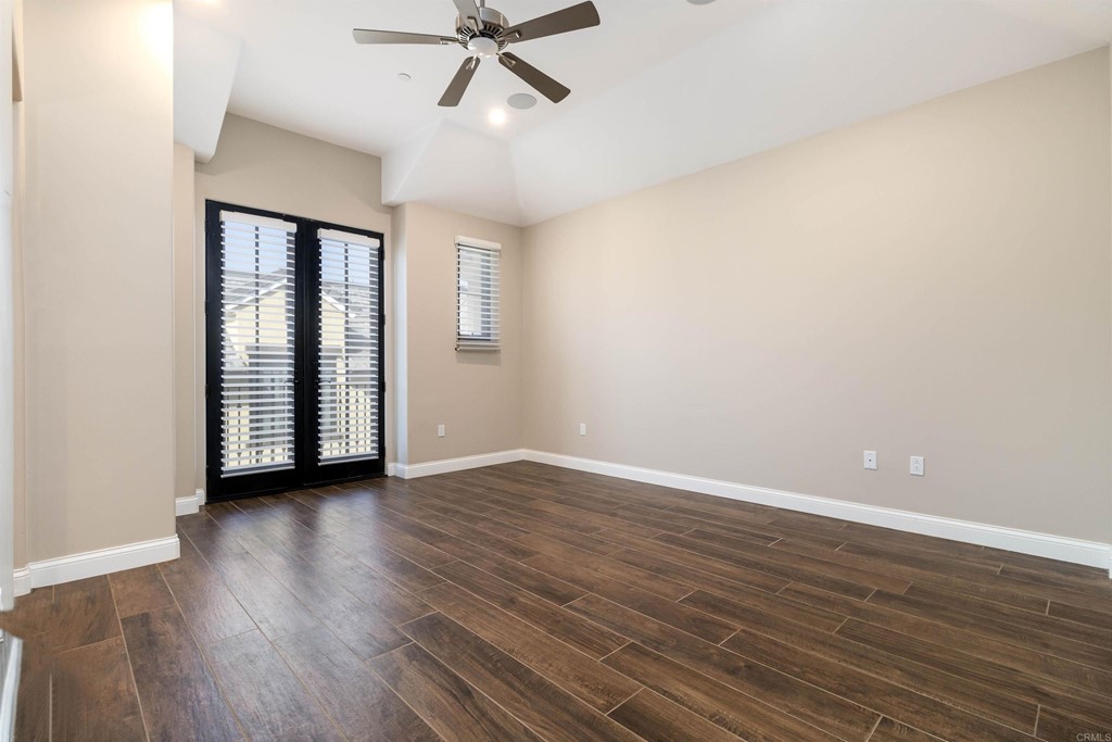 728 Silver Street La Jolla, CA 92037 - Photo 25 of 44 an empty room with wooden floor fan and windows