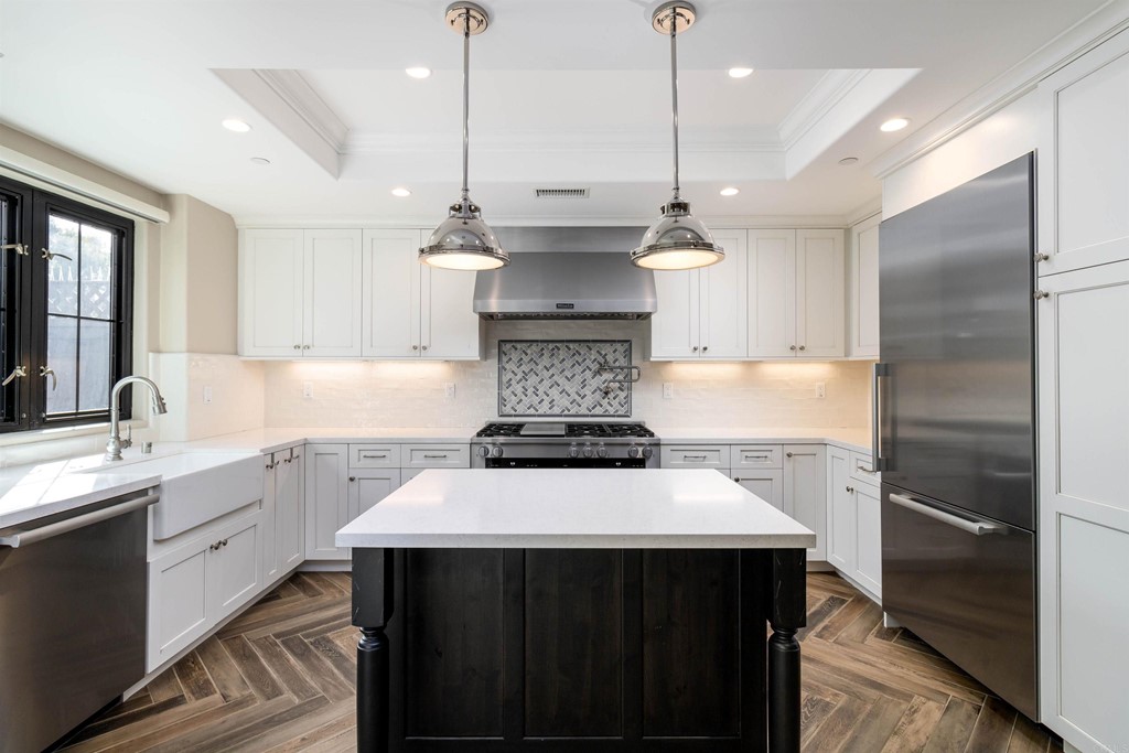728 Silver Street La Jolla, CA 92037 - Photo 7 of 44 a kitchen with a sink a stove a refrigerator and cabinets