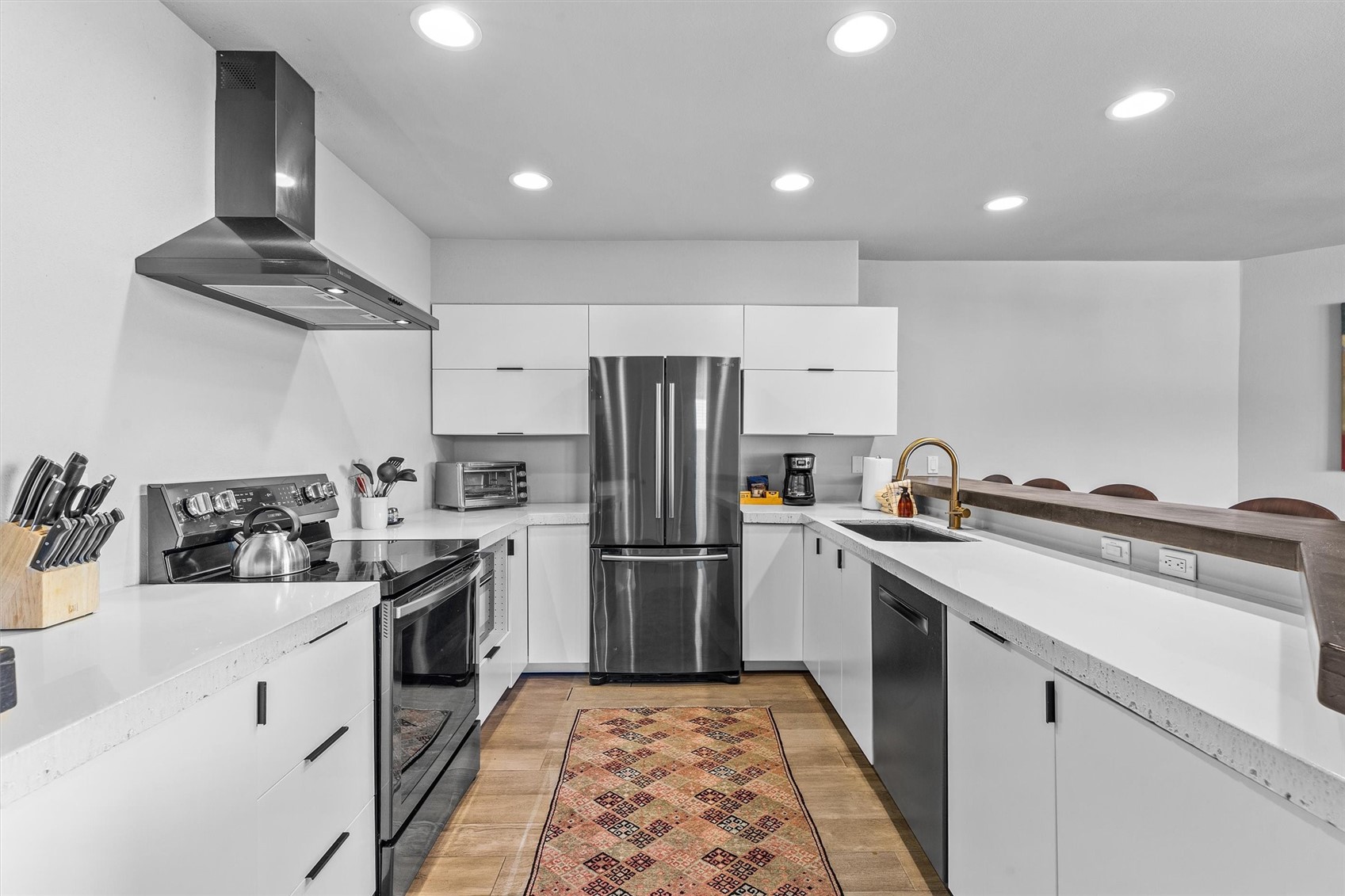 1724 Ski Time Square Drive, Unit R6 Steamboat Springs, CO 80487 - Photo 11 of 39 a kitchen with a sink stainless steel appliances and cabinets