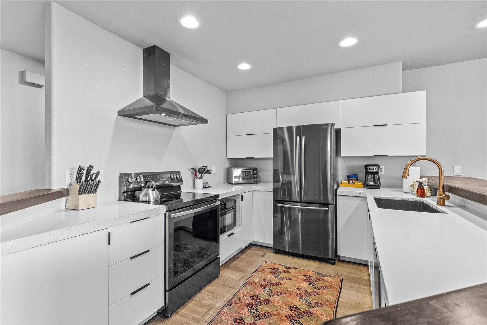 1724 Ski Time Square Drive, Unit R6 Steamboat Springs, CO 80487 - Photo 12 of 39 a kitchen with white cabinets stainless steel appliances and sink
