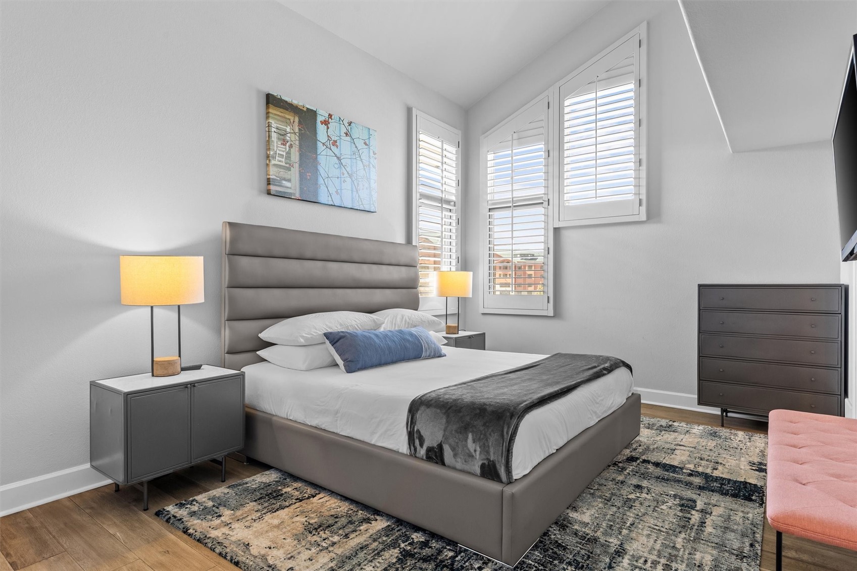 1724 Ski Time Square Drive, Unit R6 Steamboat Springs, CO 80487 - Photo 14 of 39 a bedroom with a bed a lamp and a window