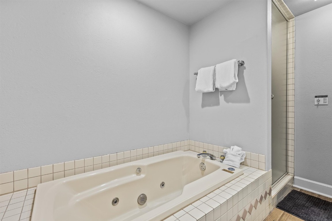 1724 Ski Time Square Drive, Unit R6 Steamboat Springs, CO 80487 - Photo 17 of 39 a bathroom with a tub and a shower curtain