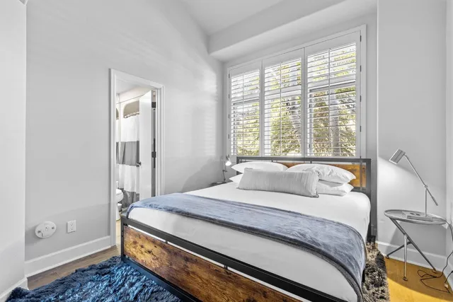 a bedroom with a bed and a window