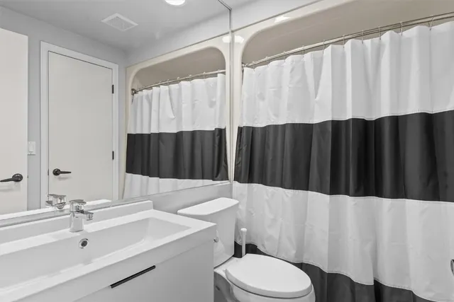 a bathroom with a sink a toilet and a tub