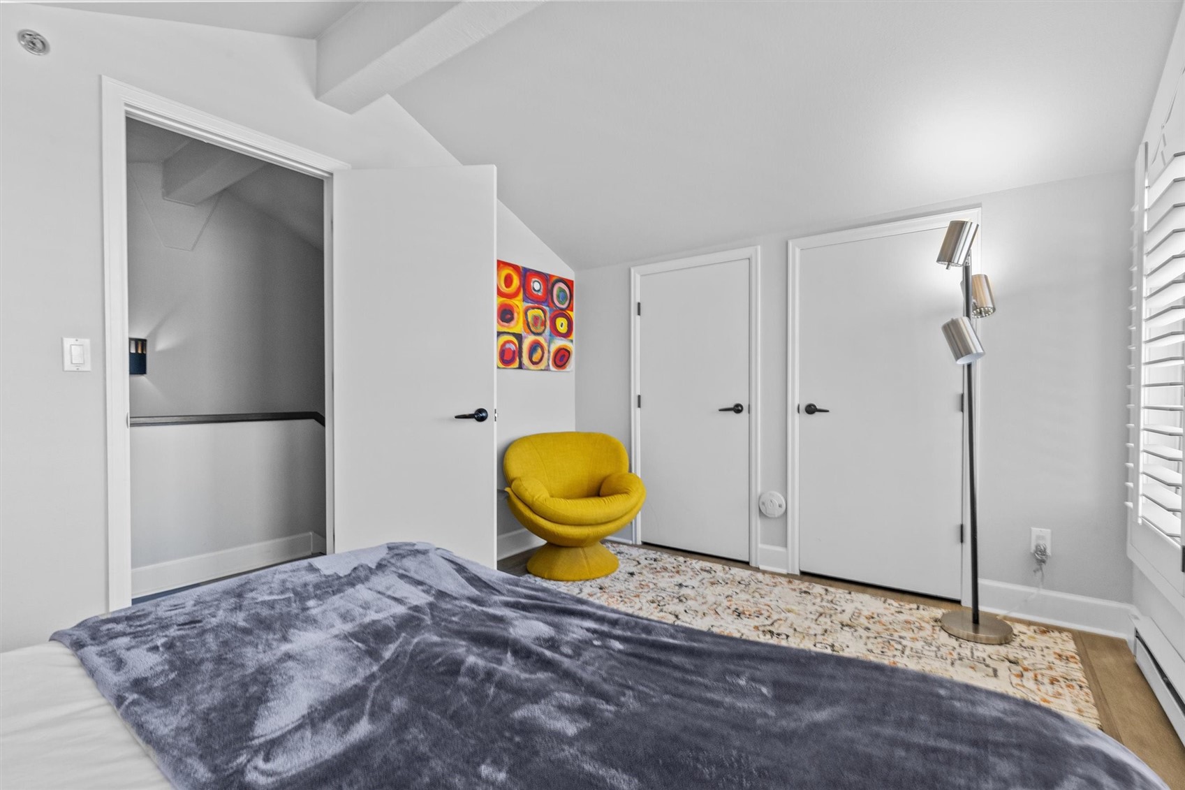 1724 Ski Time Square Drive, Unit R6 Steamboat Springs, CO 80487 - Photo 25 of 39 a bedroom with a bed and a painting on the wall