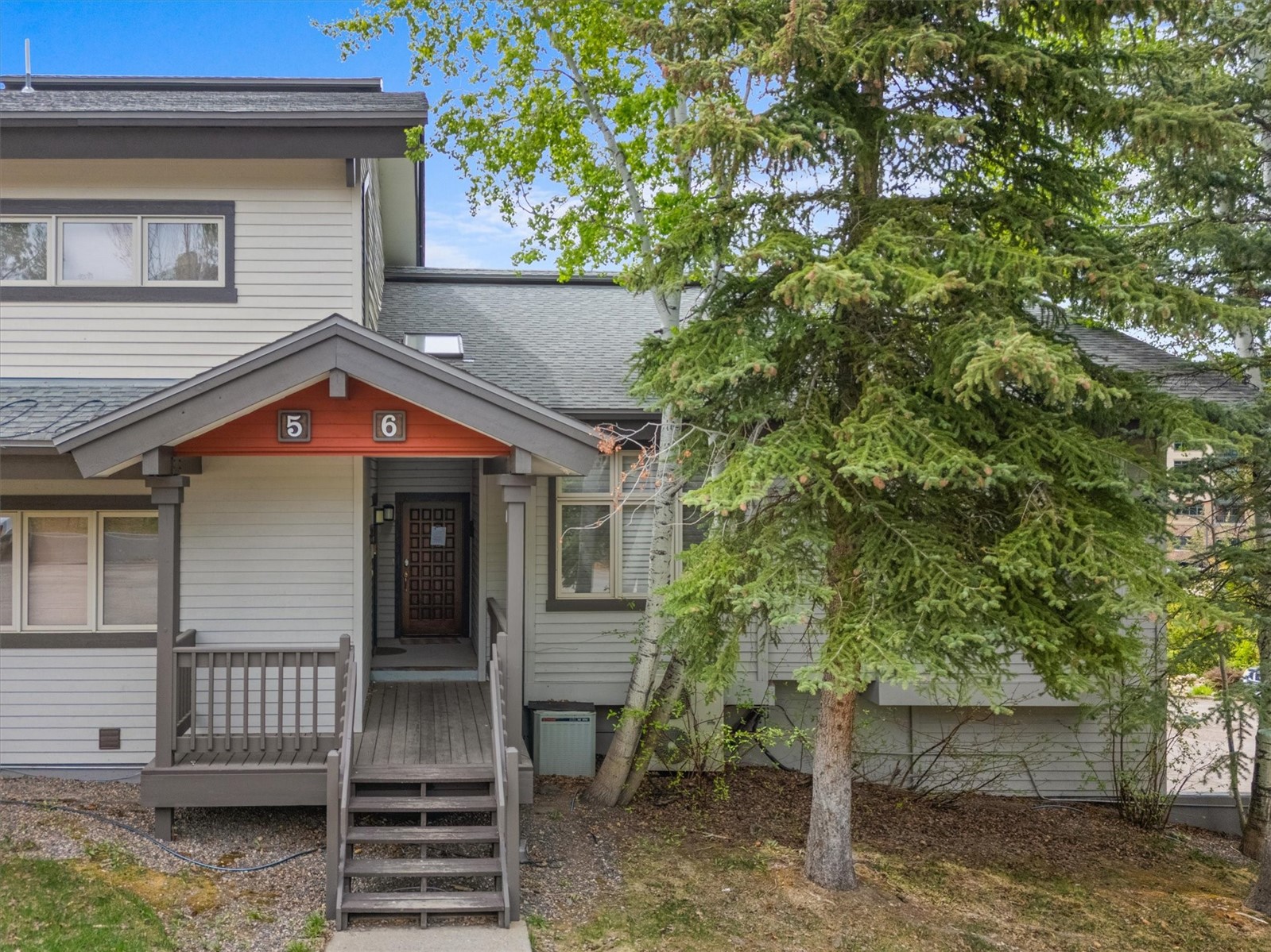 1724 Ski Time Square Drive, Unit R6 Steamboat Springs, CO 80487 - Photo 36 of 39 a view of house with a tree and wooden fence