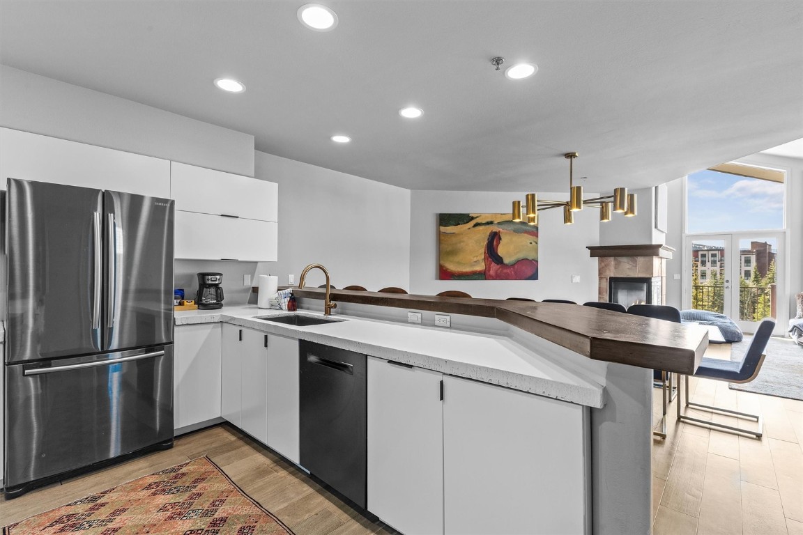 1724 Ski Time Square Drive, Unit R6 Steamboat Springs, CO 80487 - Photo 10 of 39 a kitchen that has a sink cabinets stainless steel appliances and a window