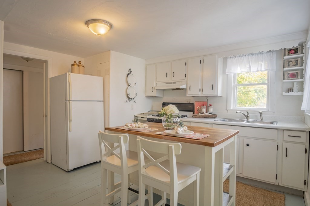 9 Nonantum Road Marblehead, MA 01945 - Photo 4 of 21 a kitchen with a refrigerator a stove a sink and a window