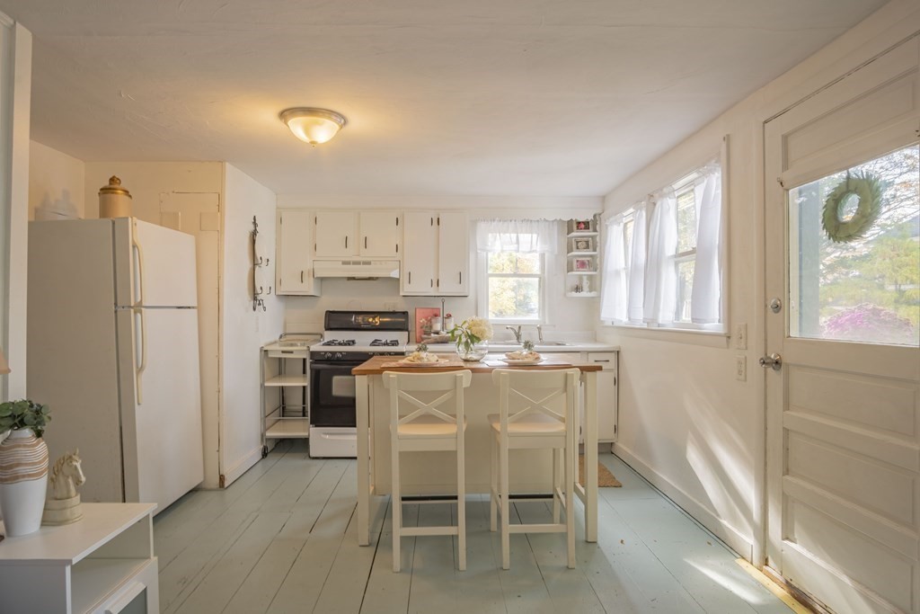 9 Nonantum Road Marblehead, MA 01945 - Photo 7 of 21 a kitchen with a refrigerator a table and chairs