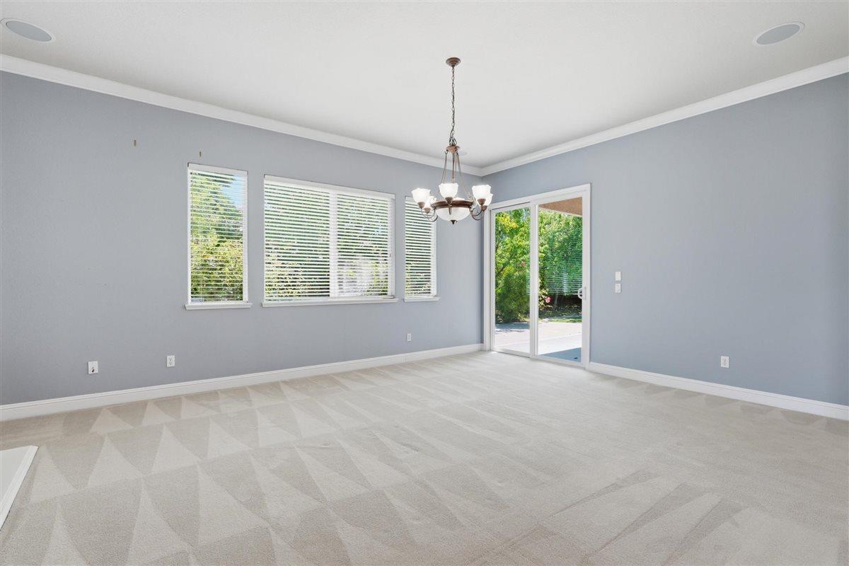 4129 Poppleton Way Carmichael, CA 95608 - Photo 19 of 48 a view of an empty room with windows and chandelier
