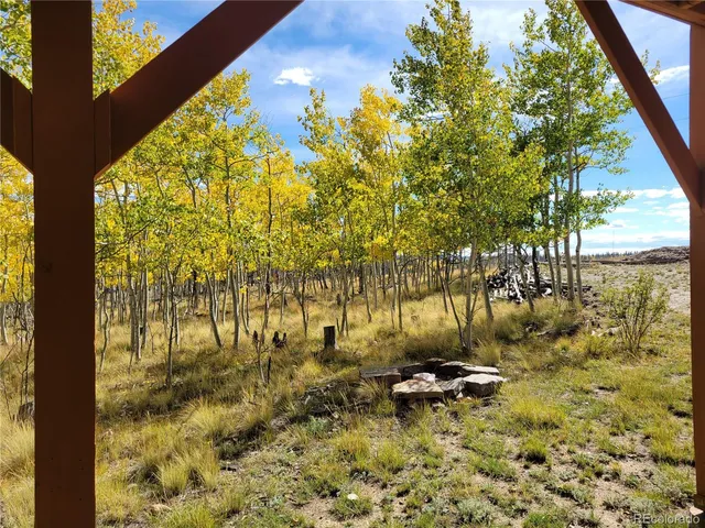 a view of balcony with wooden floor and fence