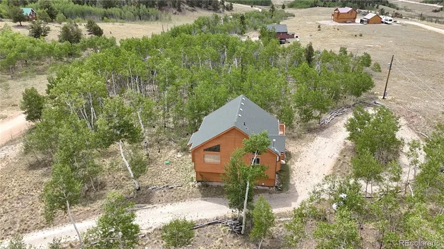 an aerial view of house with yard