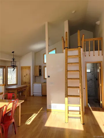 a fireplace with a clock on wall and a wooden floor