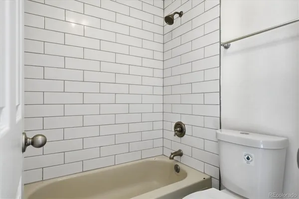 a bathroom with a bathtub and shower