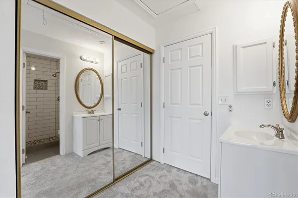 a bathroom with a sink a mirror and a shower