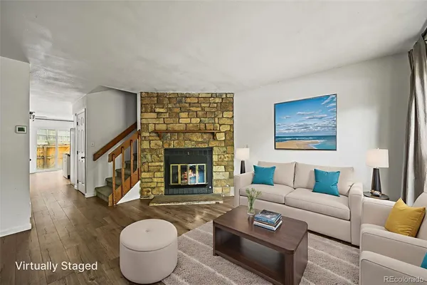 a living room with furniture and a fireplace