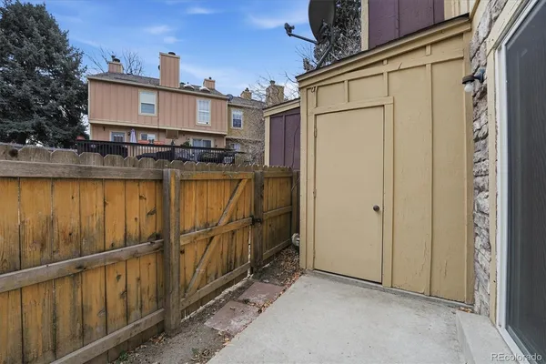 a view of a house with wooden fence
