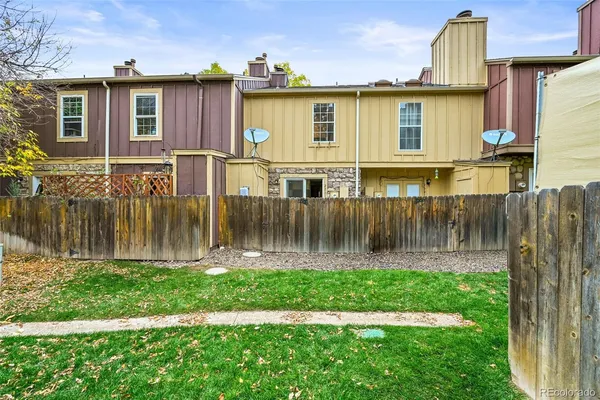 a front view of a house with a yard table and chairs