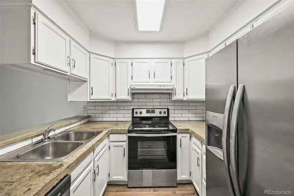 a kitchen with a stove and a refrigerator