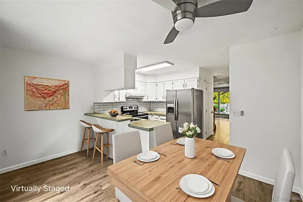 a kitchen with a table and chairs in it