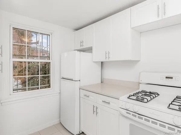 a kitchen with appliances cabinets and a counter top space