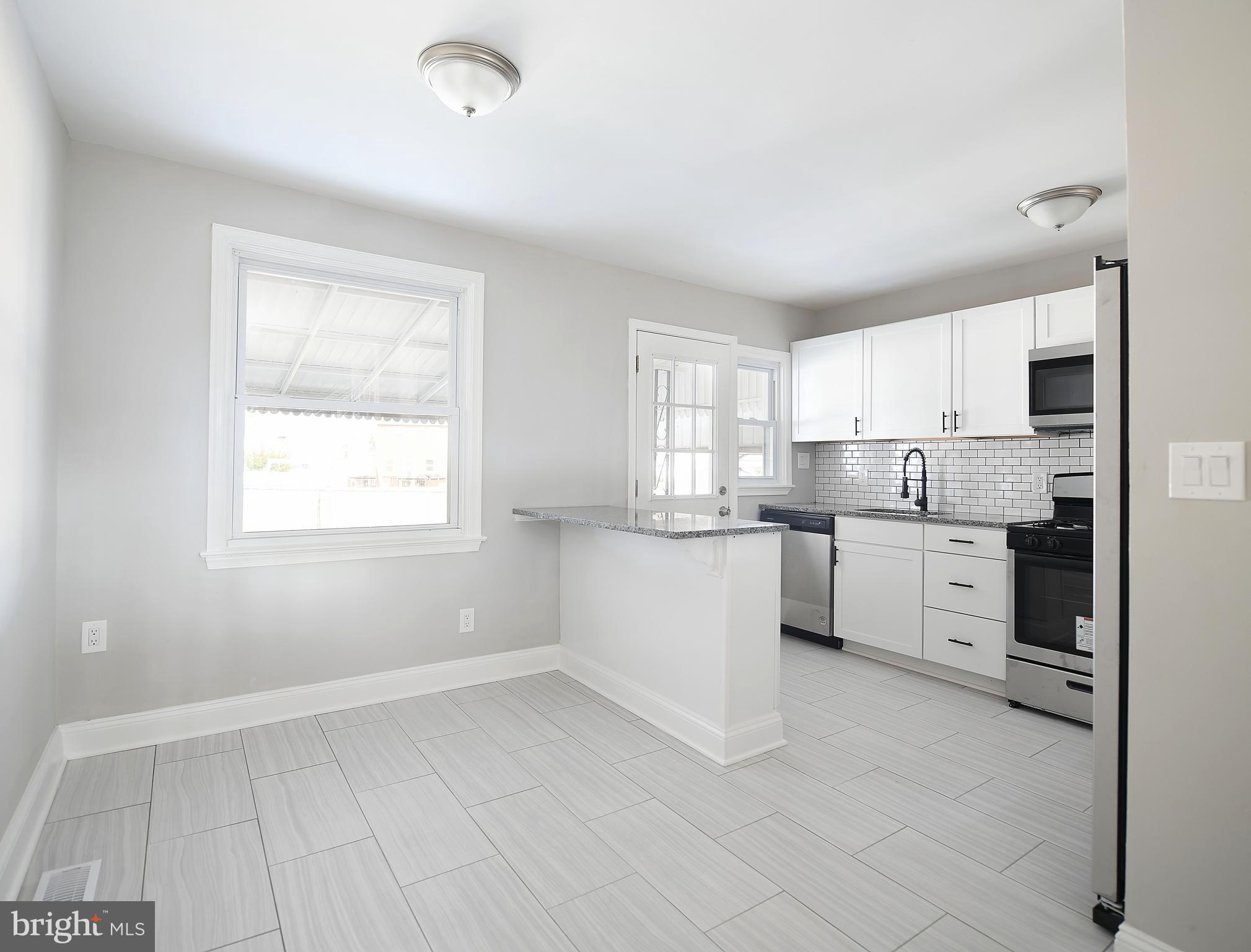 8106 Kavanagh Road Baltimore, MD 21222 - Photo 12 of 24 Dining area outfitted in bright ceramic tile