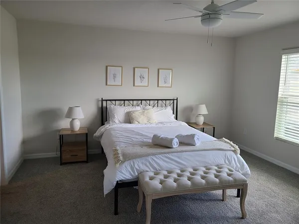 a bedroom with a bed and a window