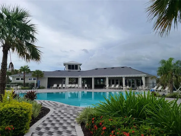 a view of a swimming pool with a garden and trees