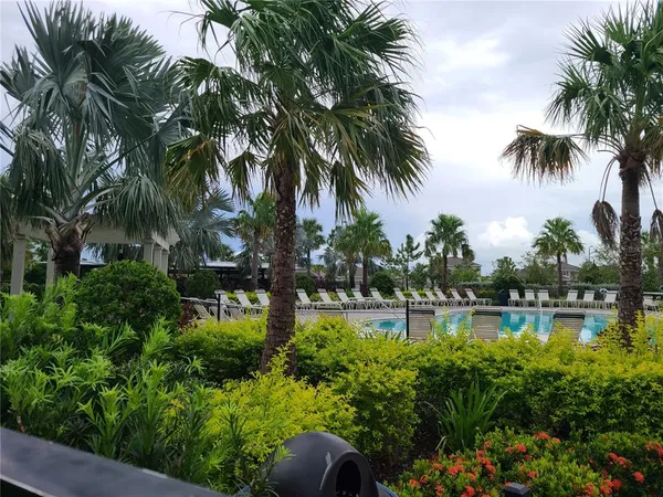 a front view of a house with a yard and potted plants
