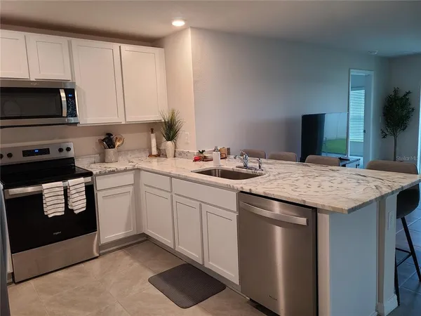 a kitchen with a sink stove and microwave