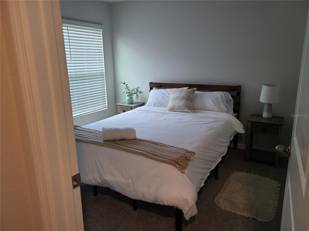 10209 Kalamazoo Place Parrish, FL 34219 - Photo 10 of 25 a bedroom with a bed and window