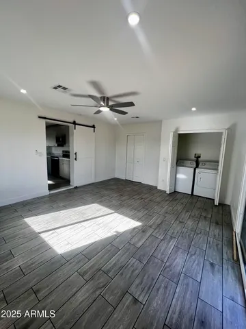 a view of empty room with wooden floor and fireplace