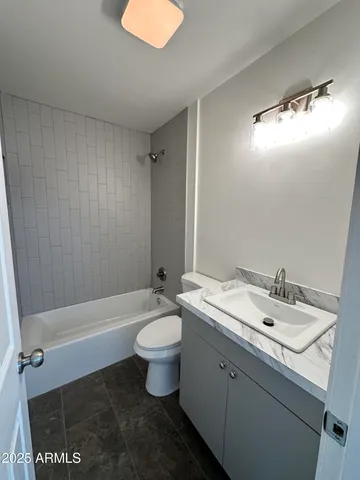 a bathroom with a sink mirror vanity and toilet