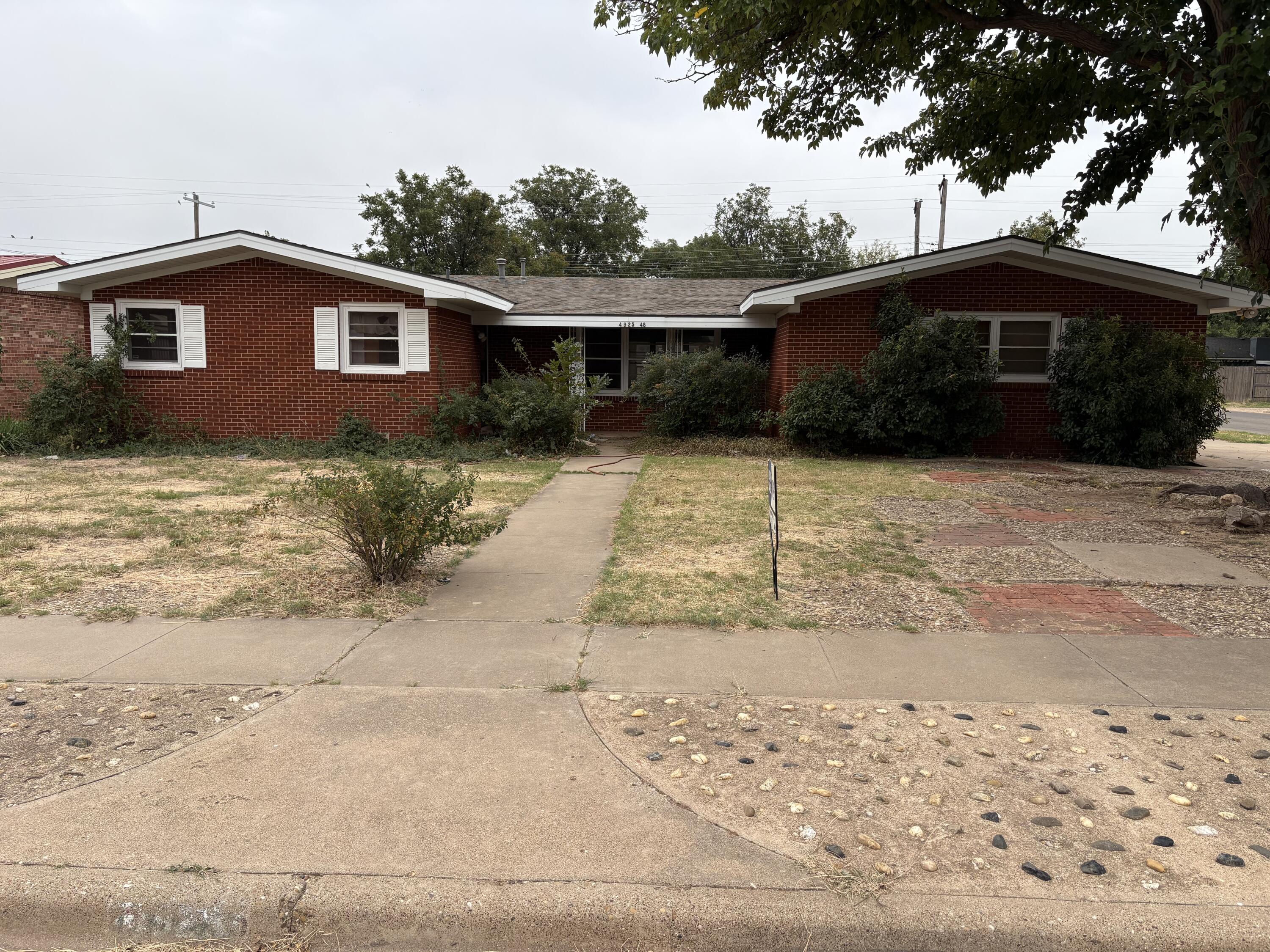 4925 48th Street Lubbock, TX 79414 - Photo 1 of 8 a front view of a house with a yard