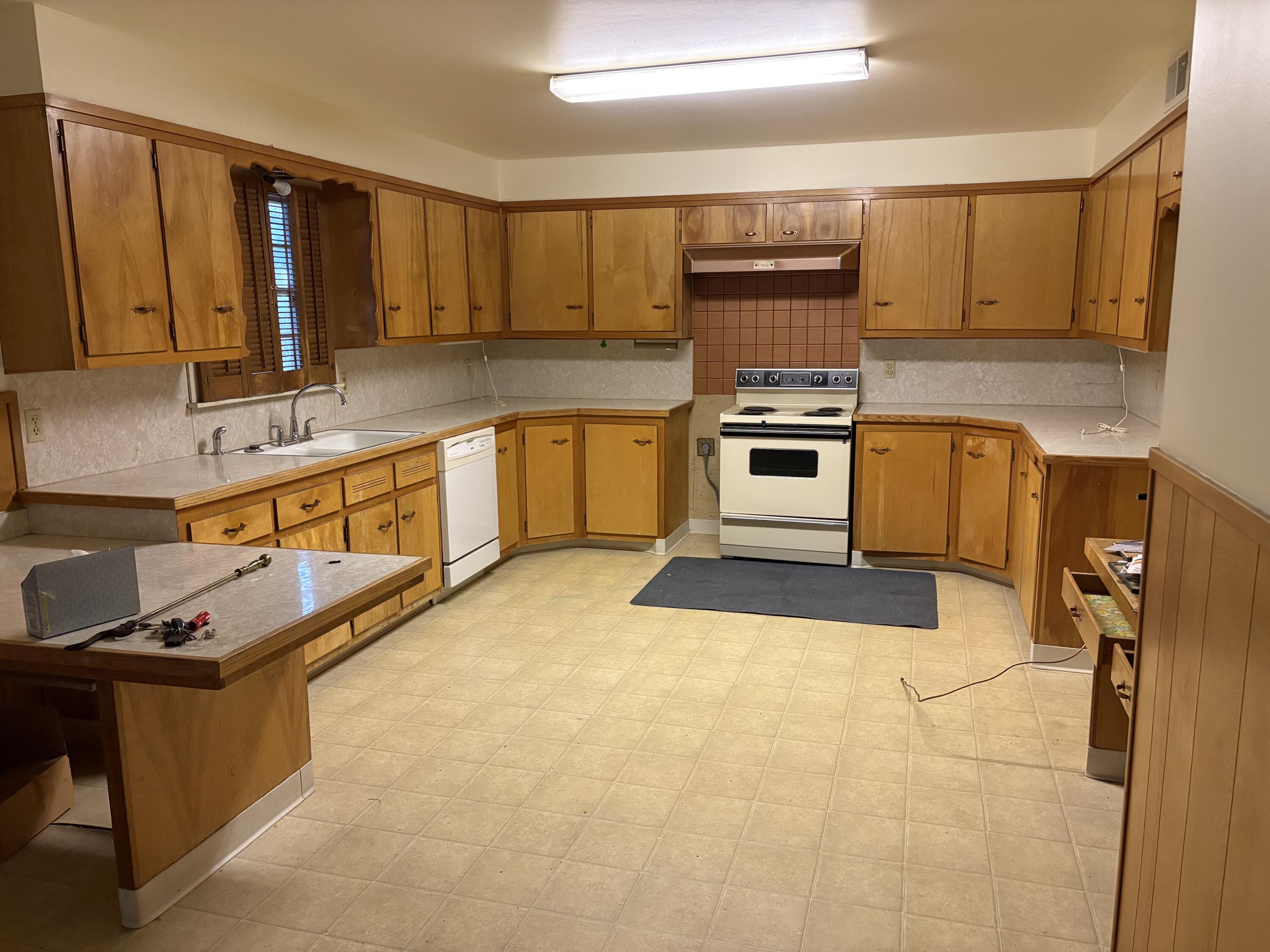 4925 48th Street Lubbock, TX 79414 - Photo 3 of 8 a kitchen with stainless steel appliances granite countertop a stove a sink and a microwave