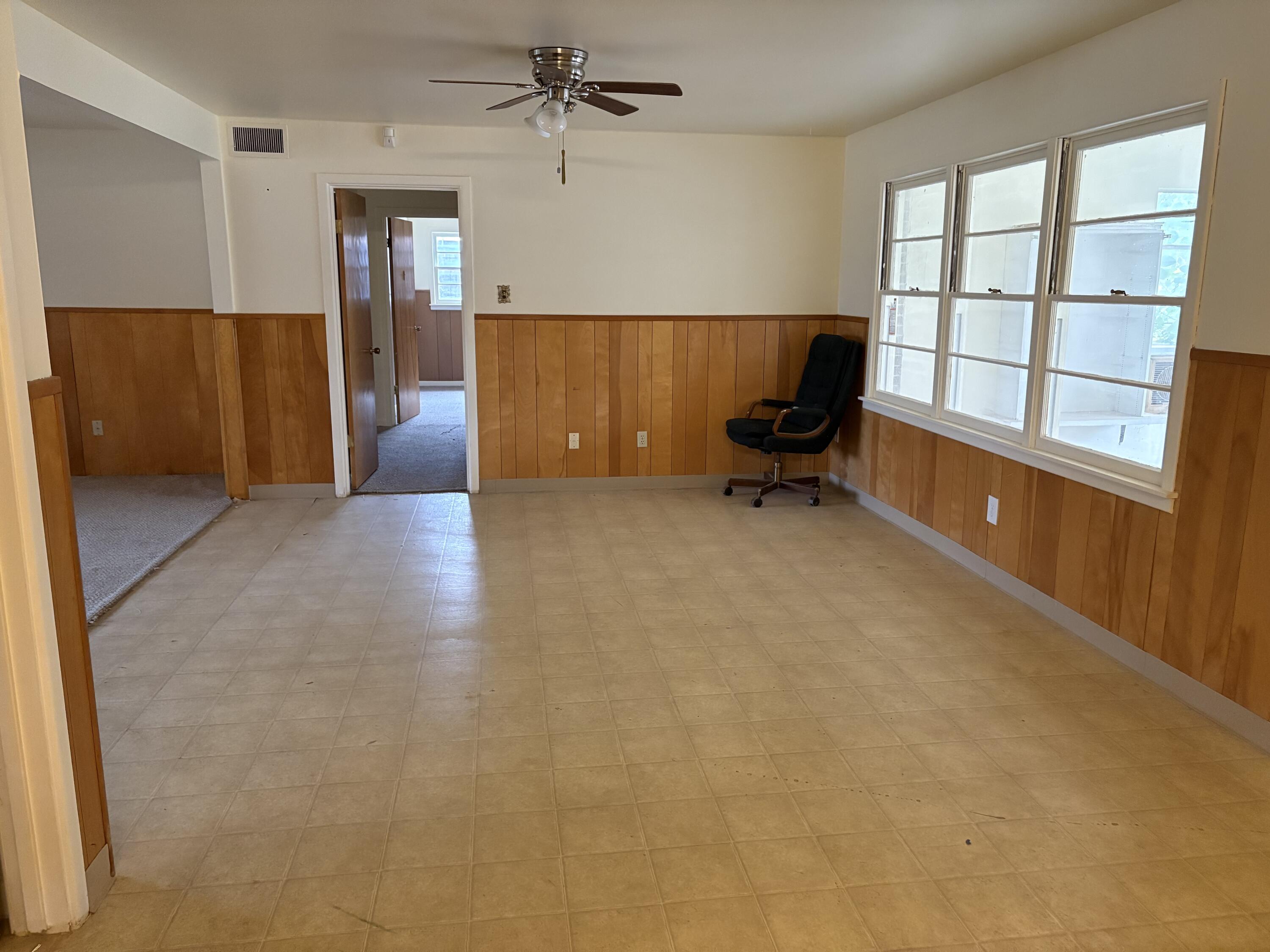 4925 48th Street Lubbock, TX 79414 - Photo 4 of 8 wooden floor in an empty room with a window