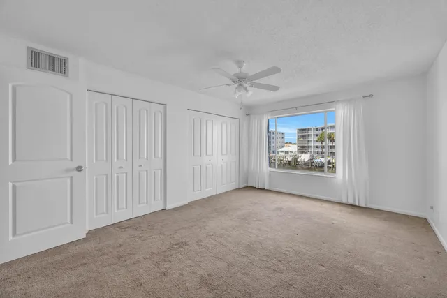 a view of an empty room and a ceiling fan