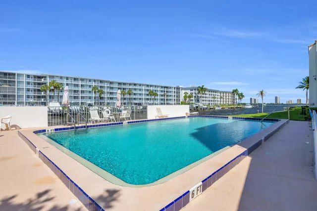 a living room with furniture and floor to ceiling windows