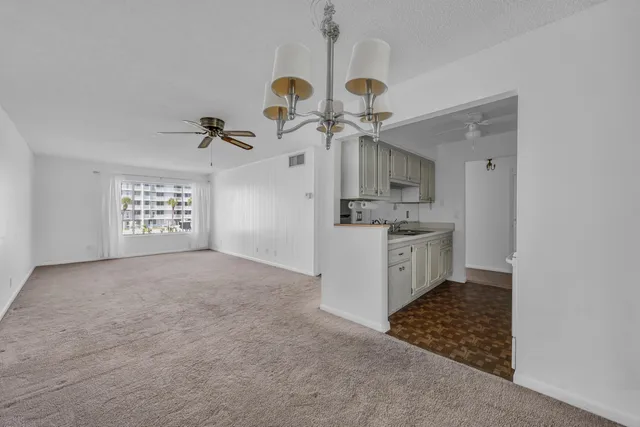 an empty room with table and fan