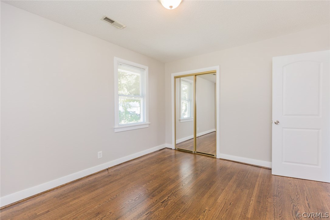 3522 West Hundred Road Chester, VA 23831 - Photo 18 of 29 an empty room with wooden floor closet and windows