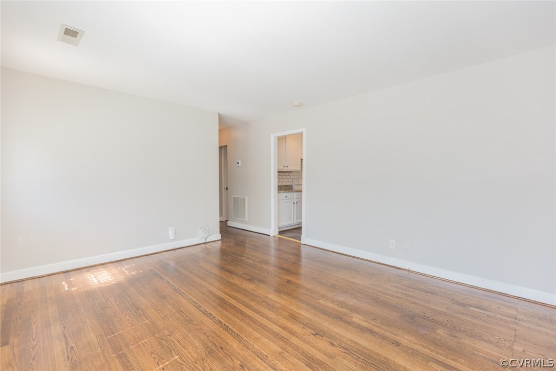 3522 West Hundred Road Chester, VA 23831 - Photo 7 of 29 a view of an empty room with wooden floor and a window