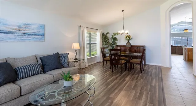 a living room with furniture and a chandelier