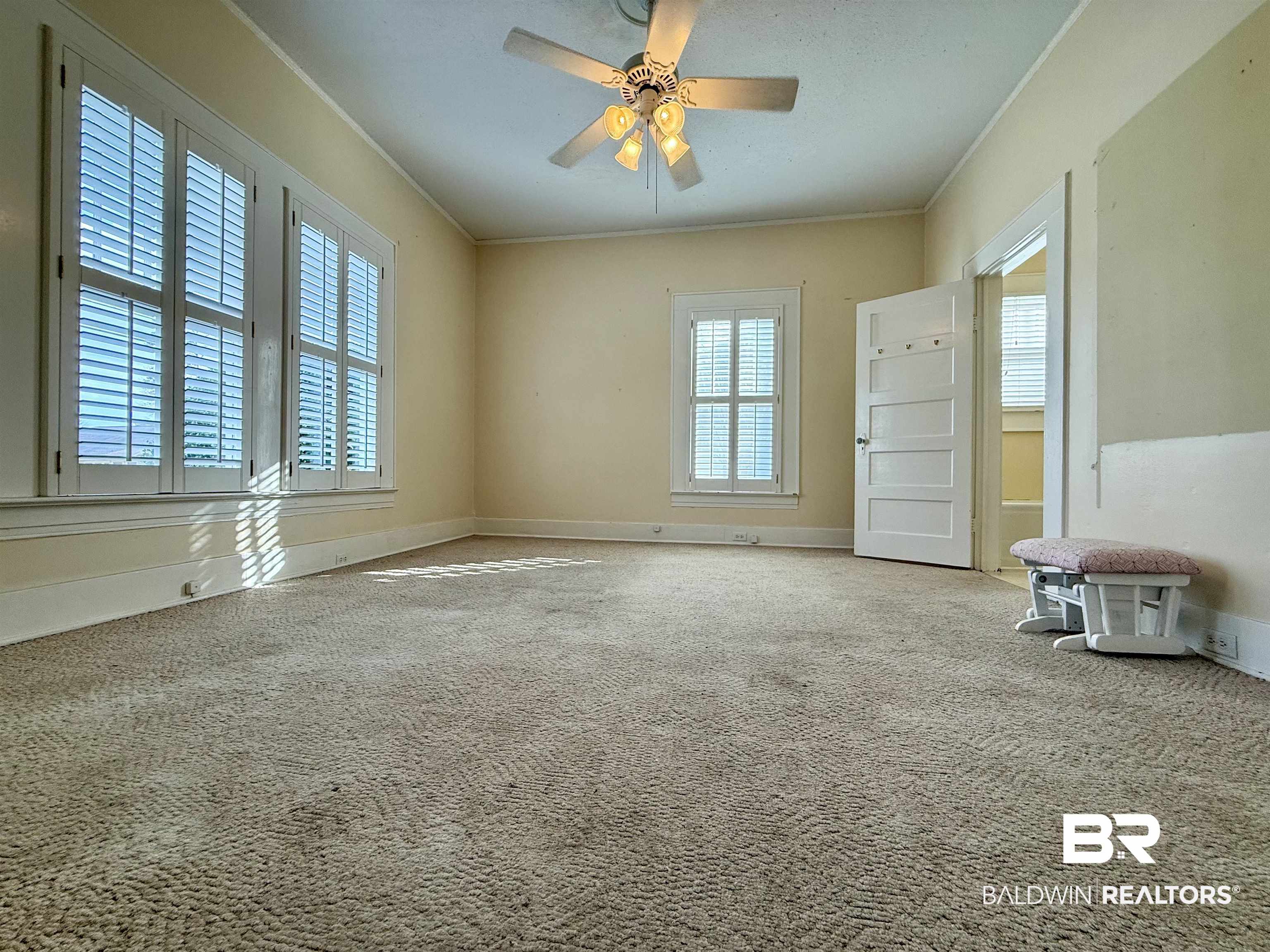 423 Evergreen Avenue Brewton, AL 36426 - Photo 12 of 18 Carpeted empty room with crown molding and ceiling fan