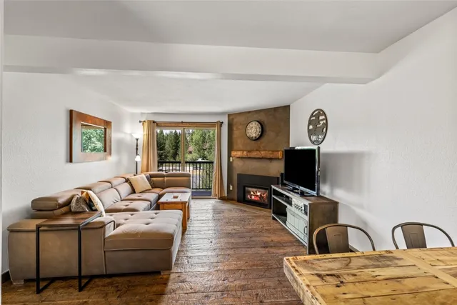 a living room with furniture flat screen tv and a fireplace