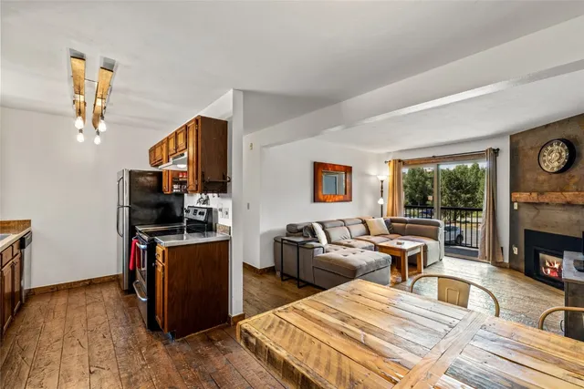 a living room with fireplace furniture and a window