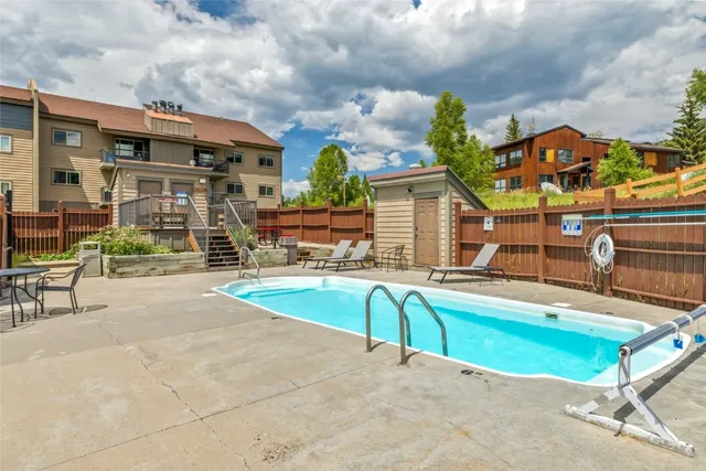 an outdoor space with swimming pool and furniture