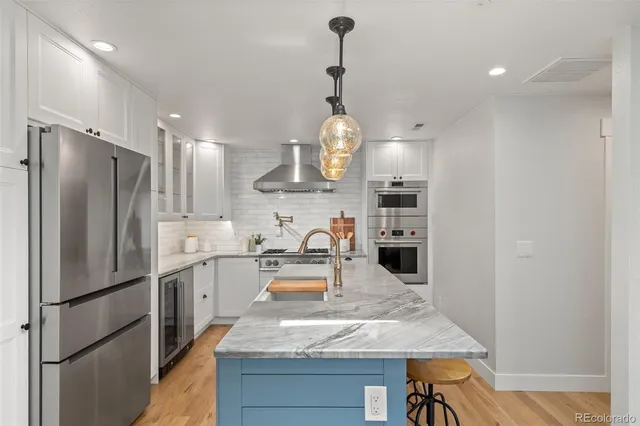 a kitchen with refrigerator a sink and cabinets