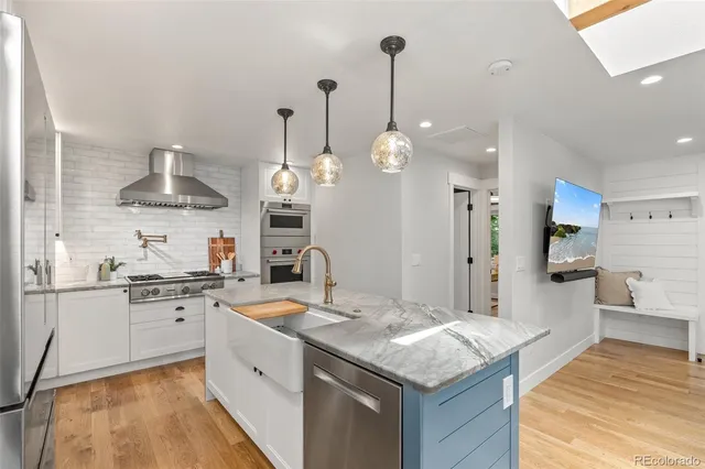 a kitchen with a sink stove and refrigerator
