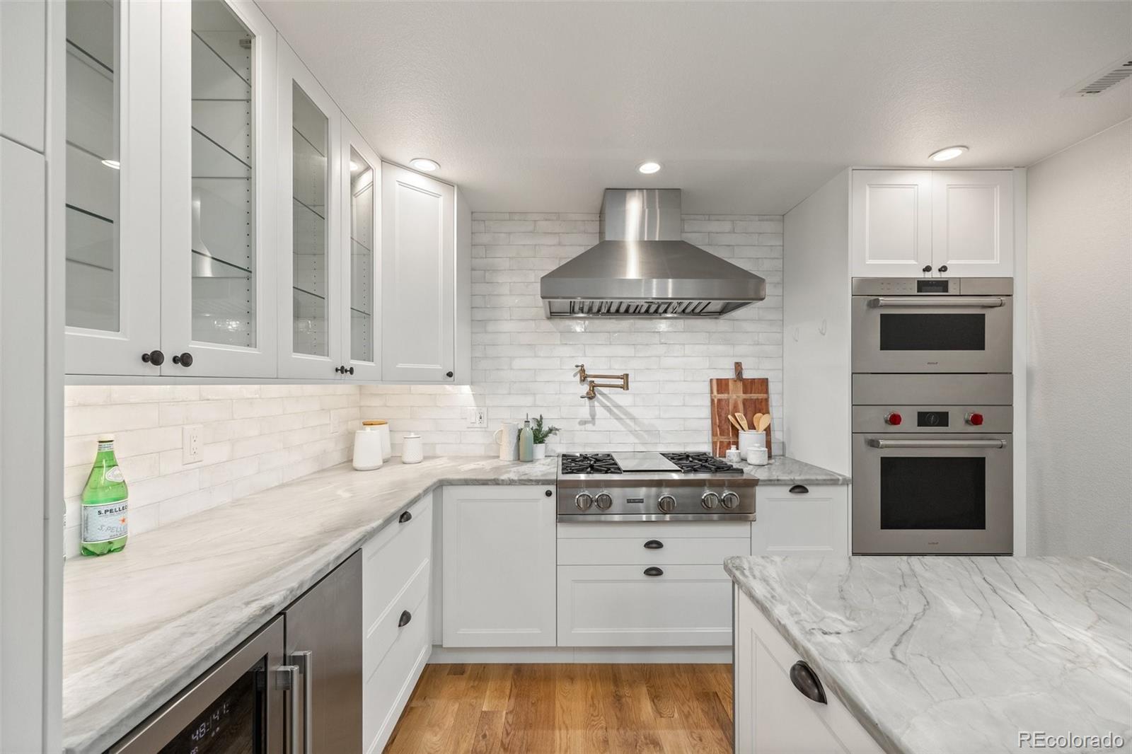 2577 Depew Street Edgewater, CO 80214 - Photo 14 of 47 a kitchen with kitchen island granite countertop stainless steel appliances a sink stove and cabinets