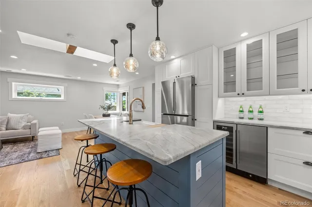 a kitchen with stainless steel appliances granite countertop a kitchen island a stove a table and chairs in it